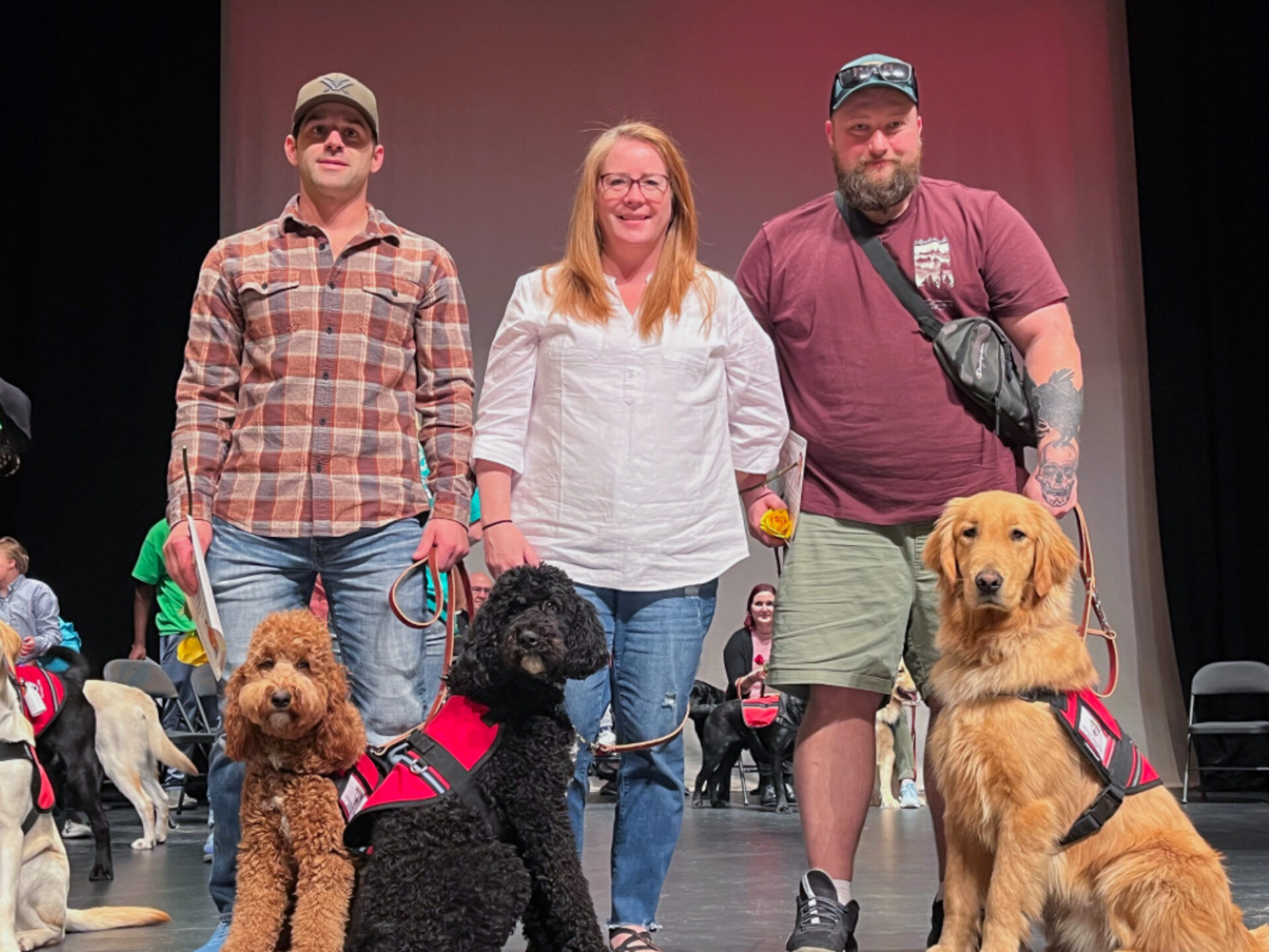 Three veterans with their service dogs