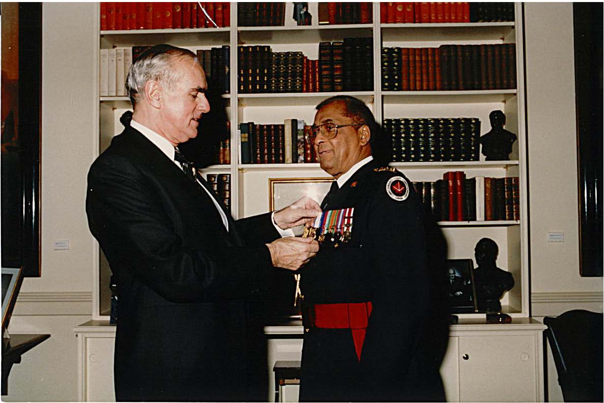 The Lieutenant Governor of Ontario presenting Major Retired Twistleton St. Rose Bertrand with the 125th Anniversary of the Confederation of Canada Medal